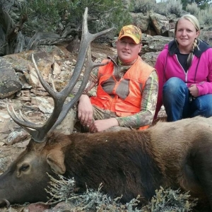 Two people posing with the elk they harvested during their Colorado hunt.