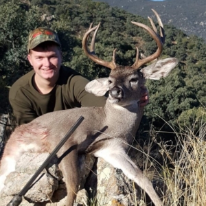 A man posing with the whitetail buck he harvested during a hunt in Sonora, Mexico.